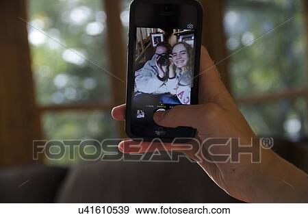 Two sisters taking selfie, Lake of the Woods, Ontario, Canada View Large Photo Image Stock Photo - Two sisters taking selfie, Lake of the Woods, Ontario, Canada. Fotosearch