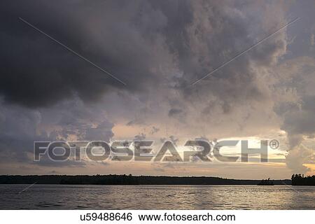 View of a lake at sunset, Lake Of The Woods, Ontario, Canada View Large Photo Image Stock Photograph - View of a lake at sunset, Lake Of The Woods, Ontario, Canada. Fotosearch