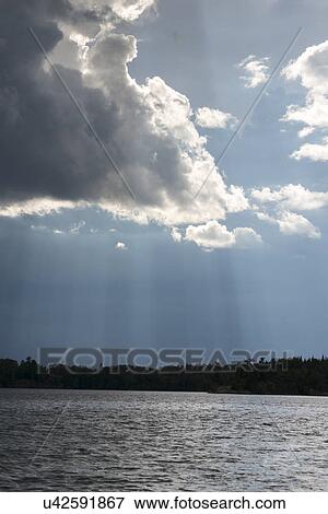 View of clouds over a lake, Lake of the Woods, Ontario, Canada View Large Photo Image Stock Photo - View of clouds over a lake, Lake of the Woods, Ontario, Canada. Fotosearch