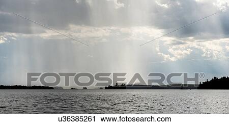 View of distant rain falling at Lake of the Woods, Ontario, Canada View Large Photo Image Stock Image - View of distant rain falling at Lake of the Woods, Ontario, Canada. Fotosearch