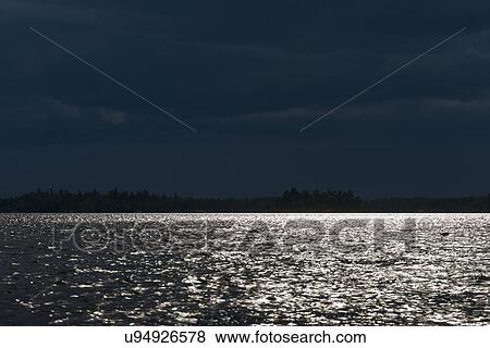 View of lake at dusk, Lake of the Woods, Ontario, Canada View Large Photo Image Stock Photo - View of lake at dusk, Lake of the Woods, Ontario, Canada. Fotosearch