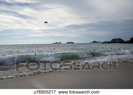 View of tourists in the ocean, enjoying the beach, Ixtapa, Guerrero, Mexico View Large Photo Image Stock Photo - View of tourists in the ocean, enjoying the beach, Ixtapa, Guerrero, Mexico. Fotosearch