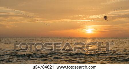 View parasailing over the ocean at sunset, Zihuatanejo, Guerrero, Mexico View Large Photo Image Stock Image - View parasailing over the ocean at sunset, Zihuatanejo, Guerrero, Mexico. Fotosearch