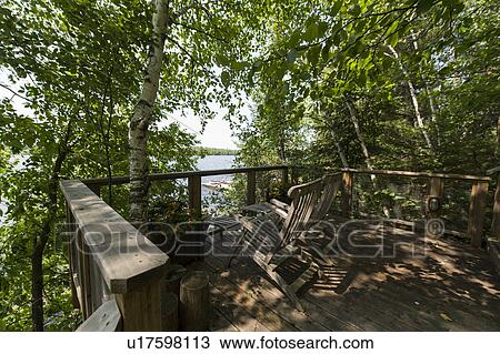 Wooden lounge chairs on a deck, Lake of the Woods, Ontario, Canada View Large Photo Image Stock Image - Wooden lounge chairs on a deck, Lake of the Woods, Ontario, Canada. Fotosearch