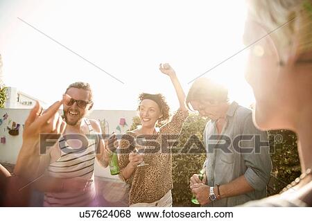 Adult friends drinking and having fun at poolside party View Large Photo Image Stock Photo - Adult friends drinking and having fun at poolside party. Fotosearch