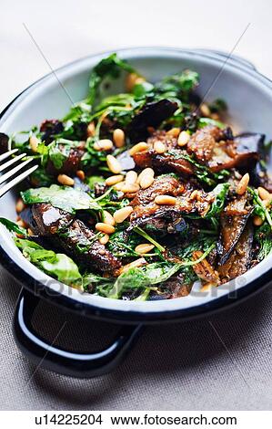 Picture - "Aubergine with pine nuts and spinach, close-up". Fotosearch