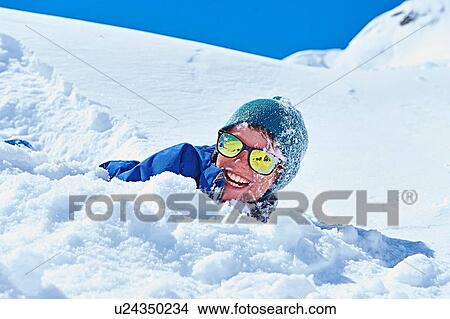 Picture - "Boy playing in snow, Chamonix, France". Fotosearch