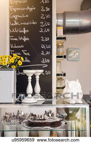 Cafe display cabinet in front of chalkboard menu View Large Photo Image Stock Photo - Cafe display cabinet in front of chalkboard menu. Fotosearch
