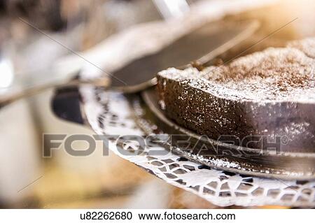 Close up of chocolate cake on doily and cake server View Large Photo Image Stock Image - Close up of chocolate cake on doily and cake server. Fotosearch