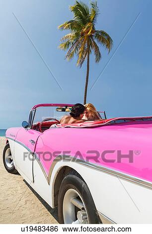 Couple in Convertible on beach View Large Photo Image Stock Photograph - Couple in Convertible on beach. Fotosearch