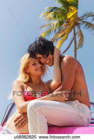 Couple on Convertible on beach View Large Photo Image Stock Image - Couple on Convertible on beach. Fotosearch
