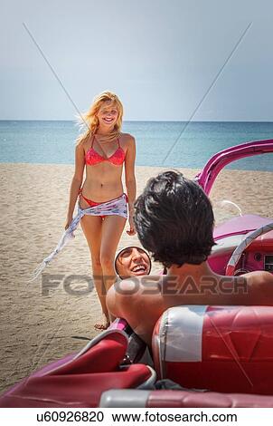 Couple with their Convertible on beach View Large Photo Image Stock Image - Couple with their Convertible on beach. Fotosearch