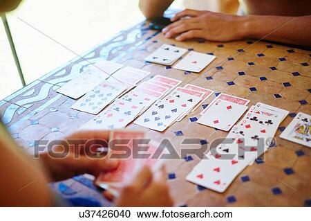 Cropped shot of mature woman and adult son playing cards at table View Large Photo Image Stock Image - Cropped shot of mature woman and adult son playing cards at table. Fotosearch