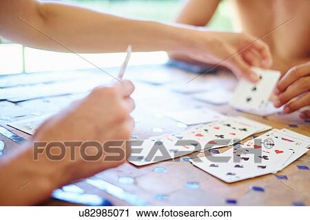 Cropped shot of mature woman and son playing cards at table View Large Photo Image Stock Image - Cropped shot of mature woman and son playing cards at table. Fotosearch