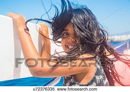 Stock Photography - "Cute girl with windswept hair on boat trip, Tarifa, Spain". Fotosearch