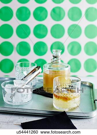 Decanter of lemon iced tea and glasses with ice on baking tin View Large Photo Image Stock Image - Decanter of lemon iced tea and glasses with ice on baking tin. Fotosearch