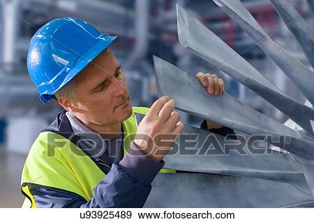 Stock Photo - Engineer checking equipment blades in geothermal power station. Fotosearch