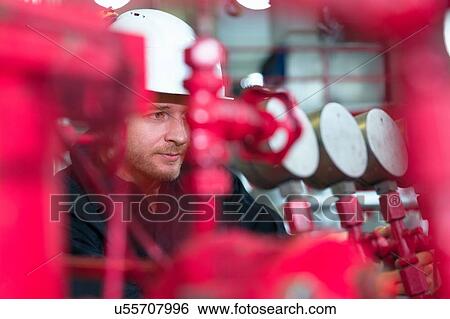 Engineer checking equipment in geothermal power station View Large Photo Image Stock Photograph - Engineer checking equipment in geothermal power station. Fotosearch