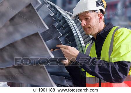 Engineer inspecting equipment blades in geothermal power station View Large Photo Image Stock Photo - Engineer inspecting equipment blades in geothermal power station. Fotosearch