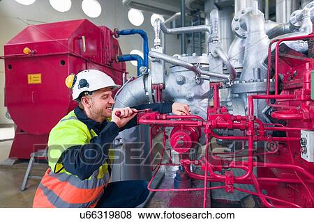 Engineer maintaining equipment in geothermal power station View Large Photo Image Stock Photo - Engineer maintaining equipment in geothermal power station. Fotosearch