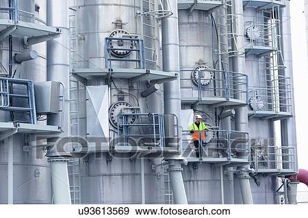 Engineer on access platform at geothermal power station View Large Photo Image Stock Photo - Engineer on access platform at geothermal power station. Fotosearch