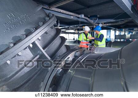 Engineers using digital tablet at geothermal power station View Large Photo Image Stock Photo - Engineers using digital tablet at geothermal power station. Fotosearch