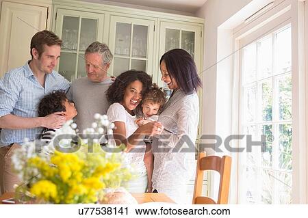 Family being greeted by grandparents on family visit View Large Photo Image Stock Image - Family being greeted by grandparents on family visit. Fotosearch