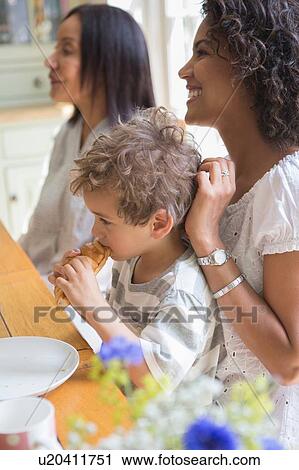 Stock Image - Family enjoying breakfast together. Fotosearch