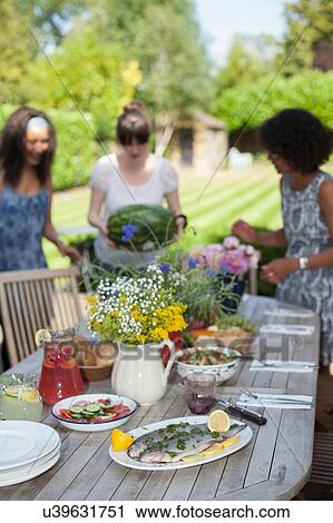 "Family enjoying meal, outdoors" View Large Photo Image Stock Image - "Family enjoying meal, outdoors". Fotosearch