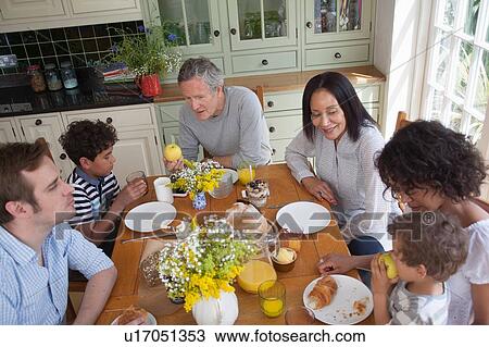 Family enjoying meal together View Large Photo Image Stock Image - Family enjoying meal together. Fotosearch