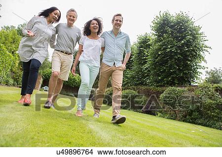 Picture - Family enjoying walk in garden. Fotosearch