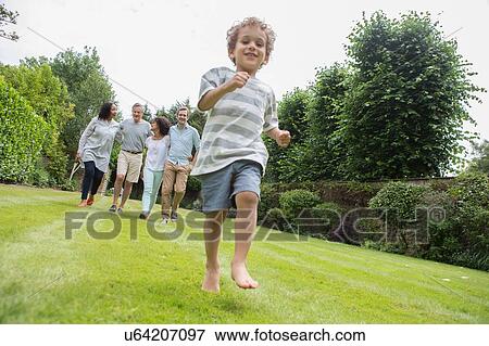 Stock Photo - Family enjoying walk in garden. Fotosearch