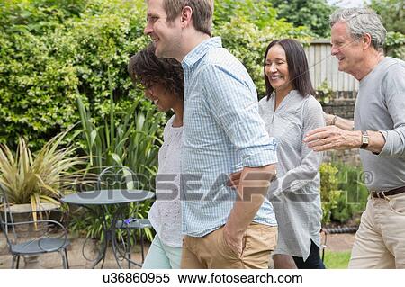 Stock Photography - Family enjoying walk in garden. Fotosearch