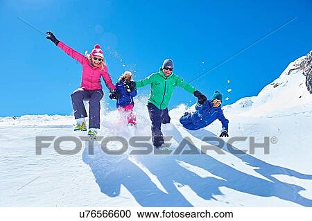 Stock Image - "Family playing in snow, Chamonix, France". Fotosearch