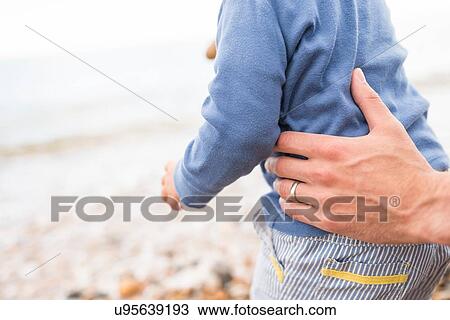 Stock Image - "Father holding young son, outdoors, mid section". Fotosearch