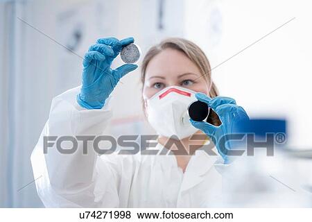 Female scientist holding plasma enhanced dispersion samples of graphene in graphene processing factory View Large Photo Image Stock Photo - Female scientist holding plasma enhanced dispersion samples of graphene in graphene processing factory. Fotosearch