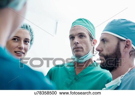 Four male and female surgeons having discussion in hospital View Large Photo Image Stock Image - Four male and female surgeons having discussion in hospital. Fotosearch