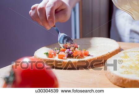 Hands of woman spreading ingredients on bread at kitchen counter View Large Photo Image Stock Photo - Hands of woman spreading ingredients on bread at kitchen counter. Fotosearch