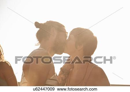 Head and shoulders of couple kissing in the sunlight View Large Photo Image Stock Photo - Head and shoulders of couple kissing in the sunlight. Fotosearch