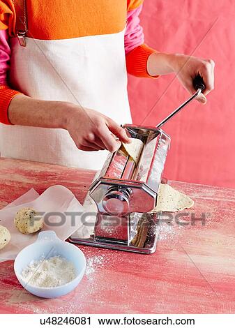 High angle view of mid adult womans mid section making pasta in pasta machine View Large Photo Image Stock Image - High angle view of mid adult womans mid section making pasta in pasta machine. Fotosearch