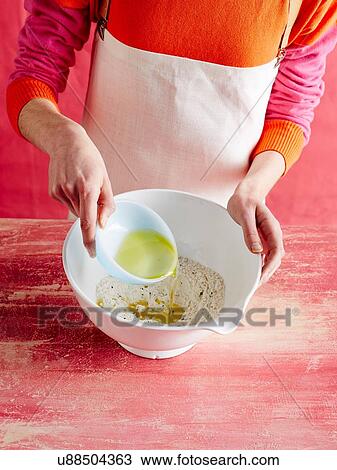 High angle view of mid adult womans mid section adding oil to dry mixture View Large Photo Image Stock Image - High angle view of mid adult womans mid section adding oil to dry mixture. Fotosearch