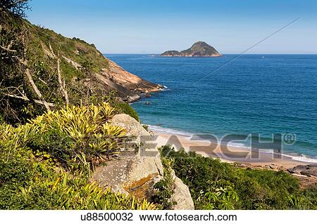 Stock Image - "High angle view of Praia Do Inferno and blue sea, Guaratiba, Rio De Janerio, Brazil". Fotosearch
