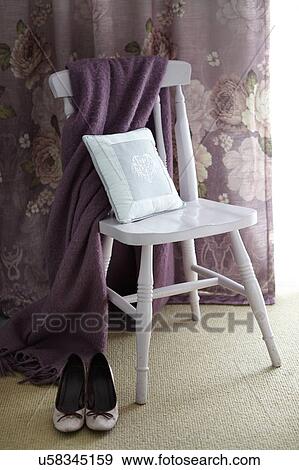 Stock Photo - "High heels, shawl and cushion on chair, curtain in background". Fotosearch