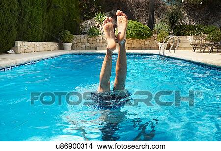Legs and feet of young man upside down in swimming pool View Large Photo Image Picture - Legs and feet of young man upside down in swimming pool. Fotosearch