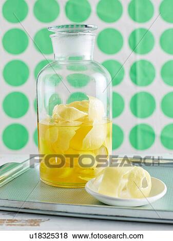 Lemon peel infusing in large glass jar to make lemon iced tea View Large Photo Image Stock Photo - Lemon peel infusing in large glass jar to make lemon iced tea. Fotosearch