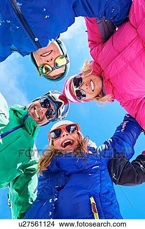 Low angle view of family in winter clothing and sunglasses View Large Photo Image Picture - Low angle view of family in winter clothing and sunglasses. Fotosearch