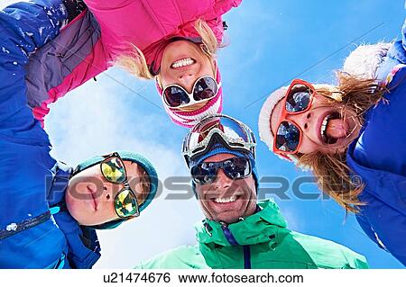 Low angle view of family in winter clothing and sunglasses View Large Photo Image Stock Photograph - Low angle view of family in winter clothing and sunglasses. Fotosearch