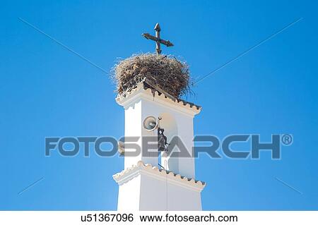 "Low angle view of large birds nest on top of church bell tower, Veyer de la Frontera, Spain" View Large Photo Image Stock Photograph - "Low angle view of large birds nest on top of church bell tower, Veyer de la Frontera, Spain". Fotosearch