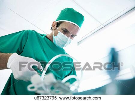 Male surgeon using surgical scissors in hospital operating theatre View Large Photo Image Stock Photography - Male surgeon using surgical scissors in hospital operating theatre. Fotosearch