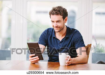Picture - Man using a digital tablet. Fotosearch